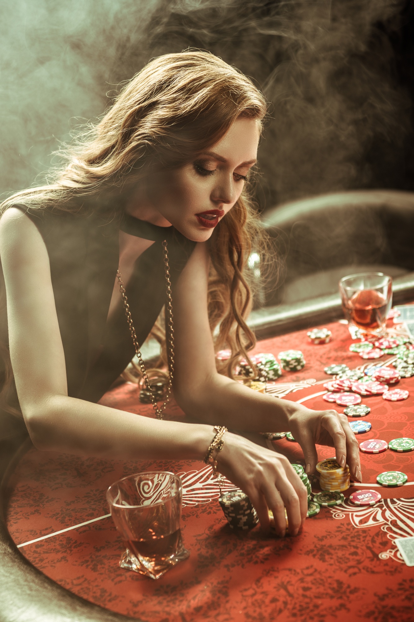 portrait of focused woman counting poker chips